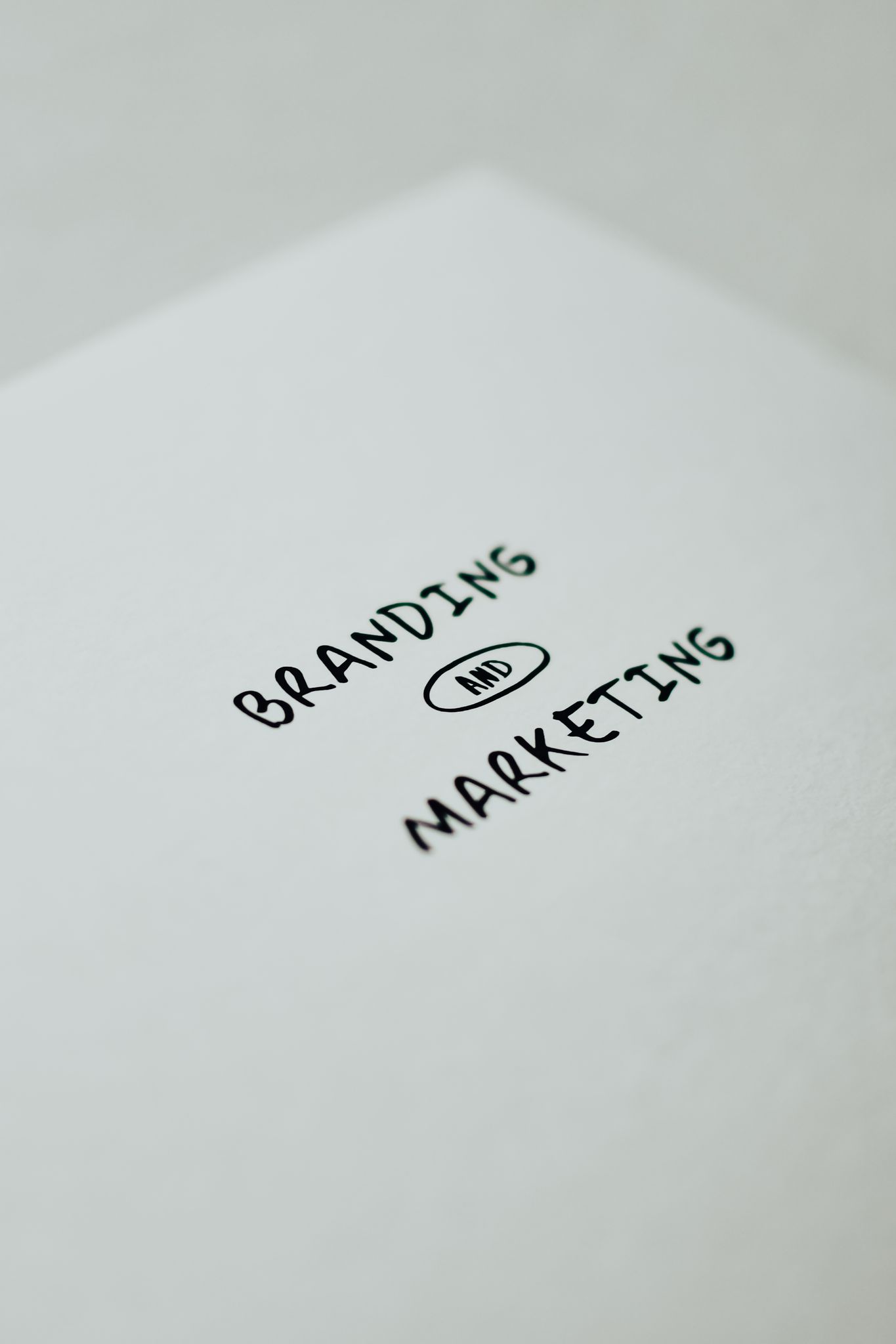 Minimalistic design showcasing 'branding and marketing' text for business strategy visuals.